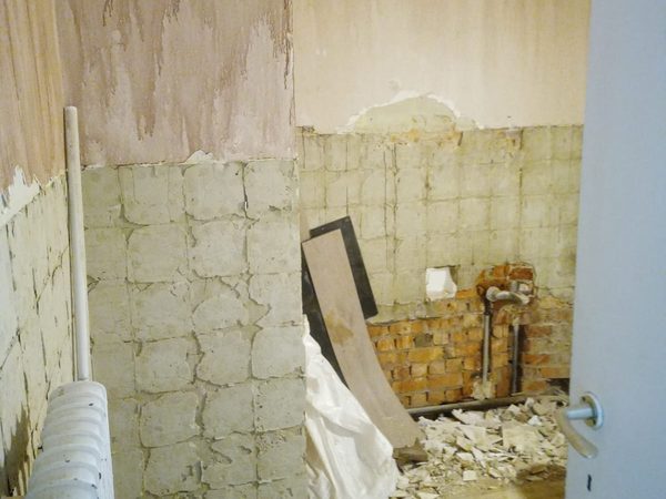 Salle de bain entièrement déposée avant rénovation, murs mis à nu